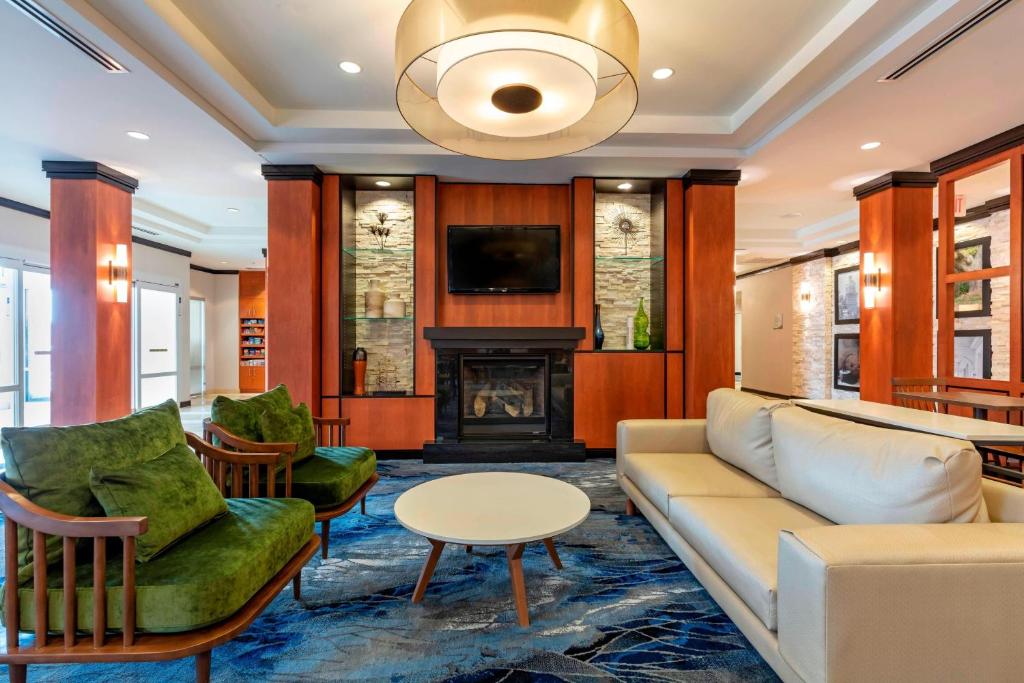 a living room with a couch and a fireplace at Fairfield Inn & Suites Columbus in Columbus