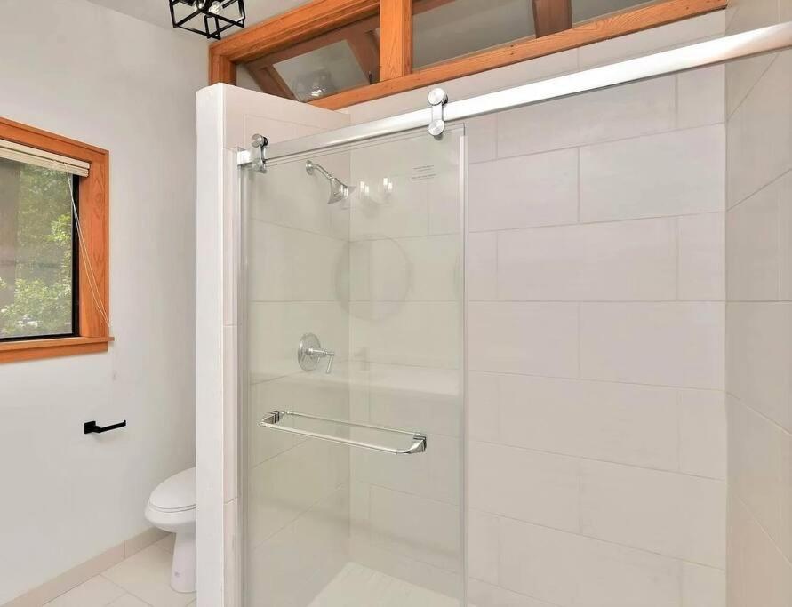 a bathroom with a glass shower with a toilet at Mountain Cabin Retreat in the Pines in Prescott