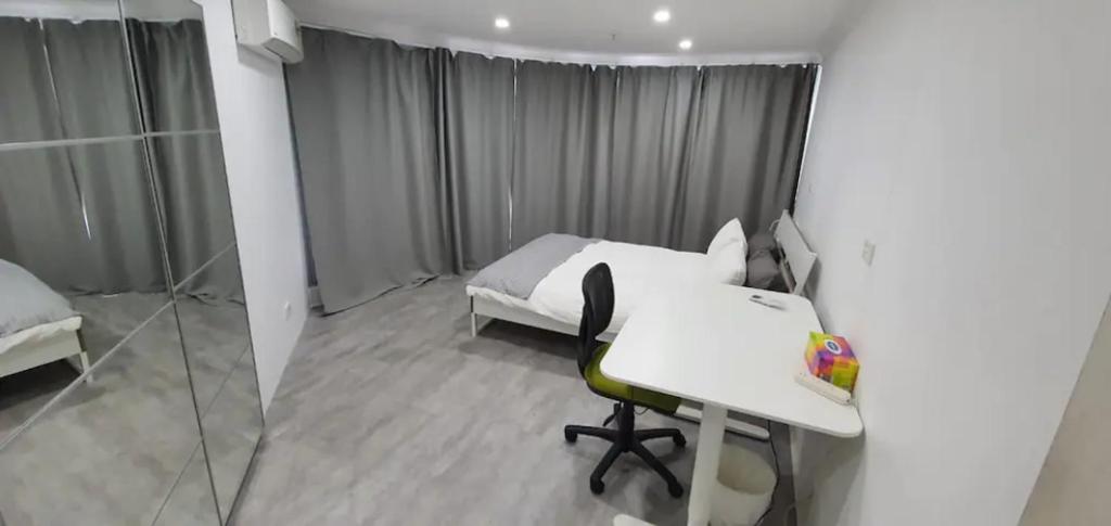 a bedroom with a white bed and a desk and a table at Dana-Spacious Private Room in Shared 2-Bedroom Apartment-2 in Canberra