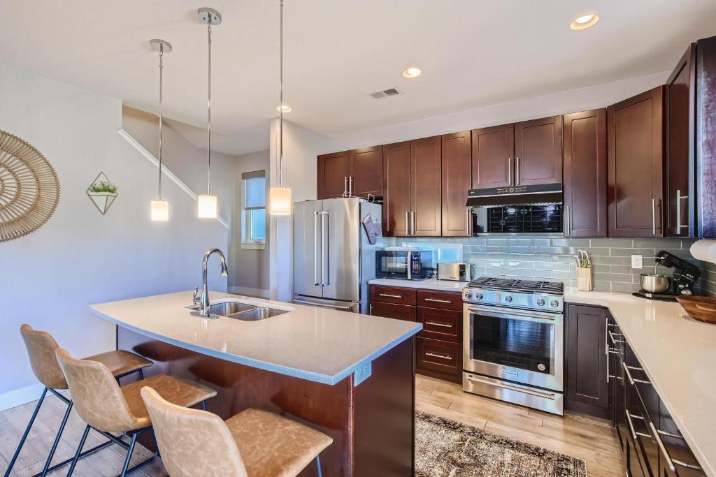 a kitchen with wooden cabinets and an island with a sink at 2332 N Clay Street Unit #3 in Denver