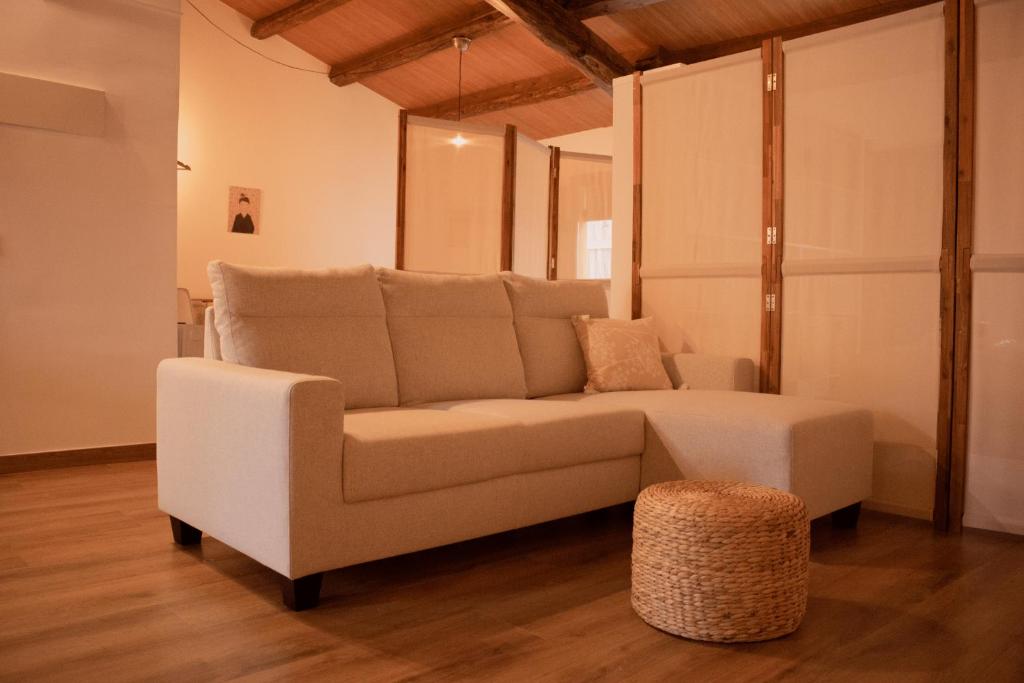 ein Wohnzimmer mit einem Sofa und einem Stuhl in der Unterkunft MonResidence La Figuereta in Manresa