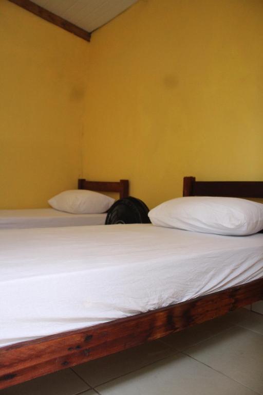 Postel nebo postele na pokoji v ubytování ROSÁRIO TEMPORADA Hostel