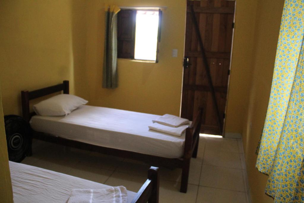 Postel nebo postele na pokoji v ubytování ROSÁRIO TEMPORADA Hostel