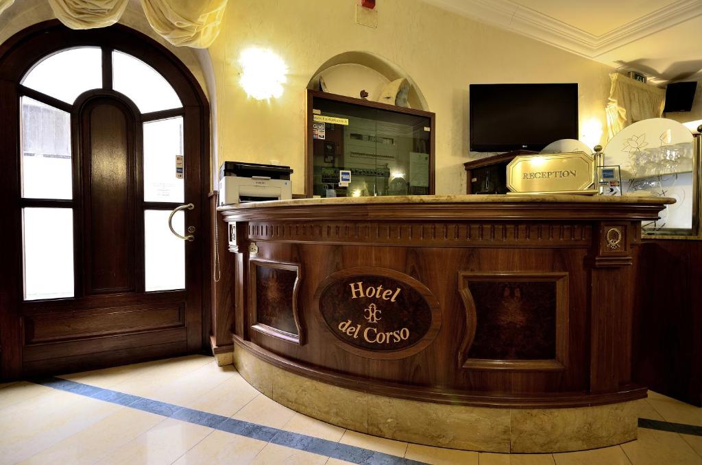 a bar in a restaurant with a sign on it at Hotel Del Corso in SantʼAntìoco