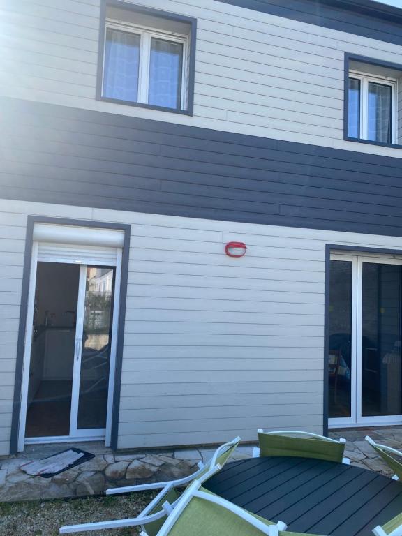 a house with a door and a patio in front of it at Saint Georges de didonne in Saint-Georges-de-Didonne