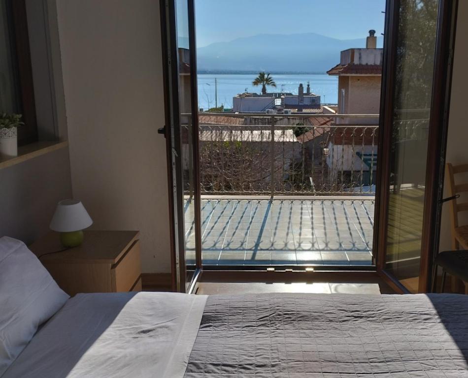 a bedroom with a bed and a view of a balcony at Garden House Alla Torre in Isola delle Femmine