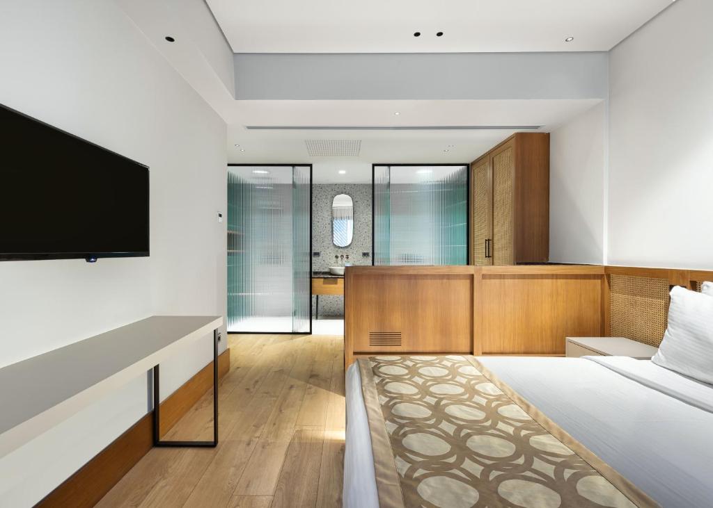 a bedroom with a bed and a flat screen tv at Galata Rasso Hotel in Istanbul