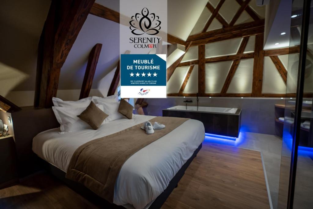 a bedroom with a bed with a sign on the wall at SERENITY Colmar - Gîtes de Prestige 4 et 5 étoiles - 2, 4 et 6 personnes- Centre Historique in Colmar