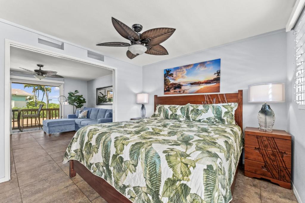a bedroom with a bed and a ceiling fan at Wailana Sands 206 in Kihei