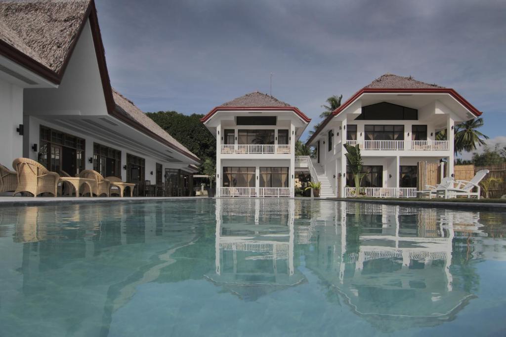 a swimming pool in front of a resort at Sea Dream Resorts in Dauin