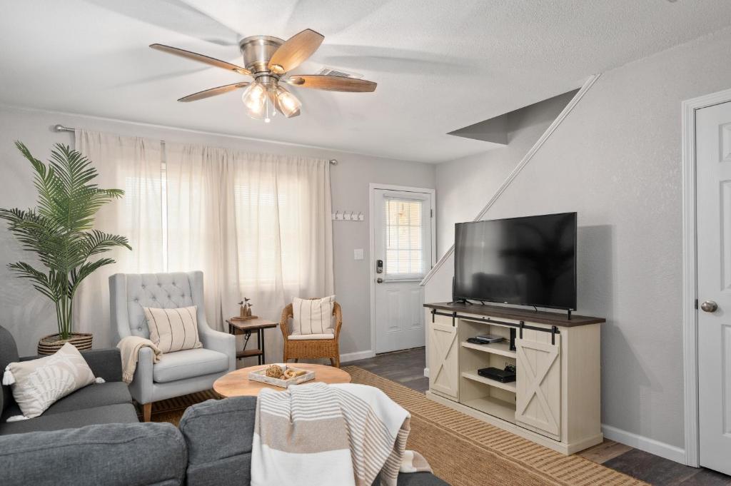 a living room with a couch and a flat screen tv at Beach Twin B KDH123B in Kill Devil Hills