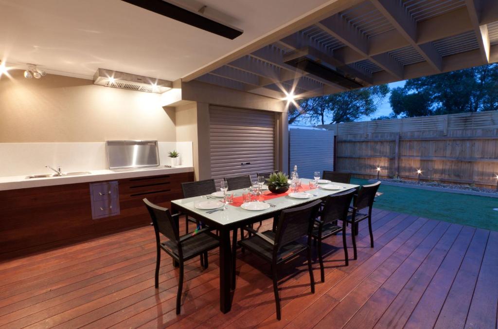 a kitchen and dining room with a table and chairs at Amaroo in Queenscliff