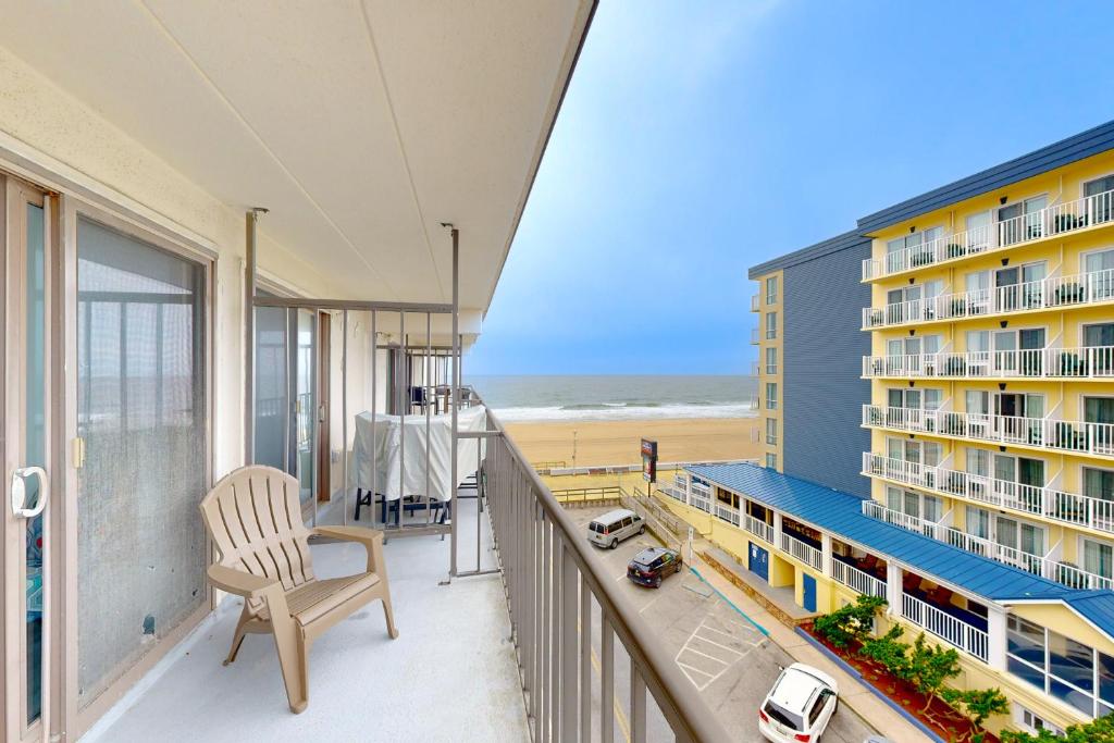 a balcony with a chair and a view of the beach at Decatur House 501 in Ocean City