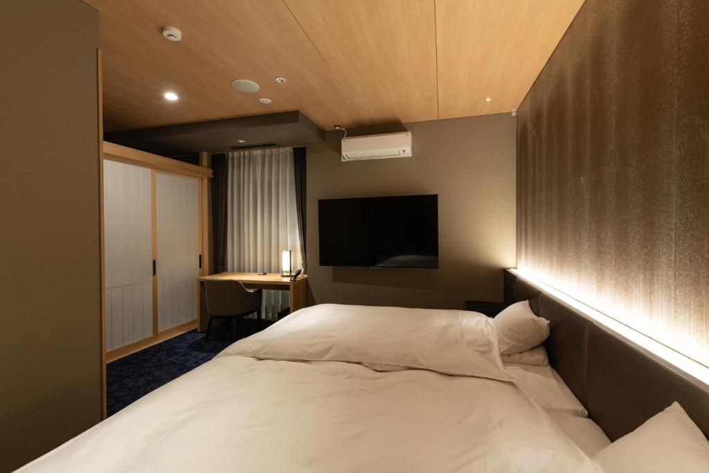 Postel nebo postele na pokoji v ubytování Arima Onsen ShikinoIrodori Hatago