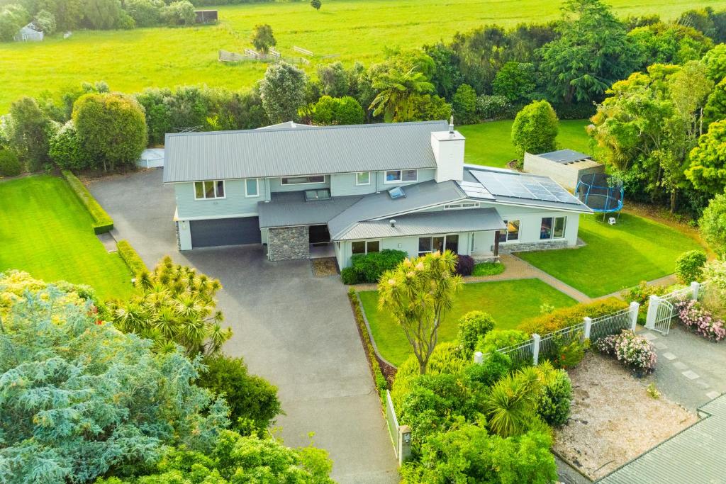 an aerial view of a house with a yard at Anam Cara Gardens luxury Villa in Otaki