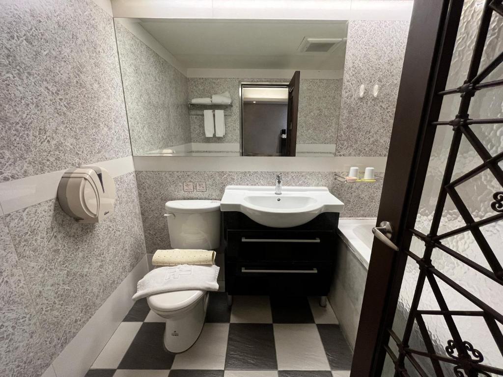 a bathroom with a toilet and a sink at Guide Hotel Taipei Xinyi in Taipei