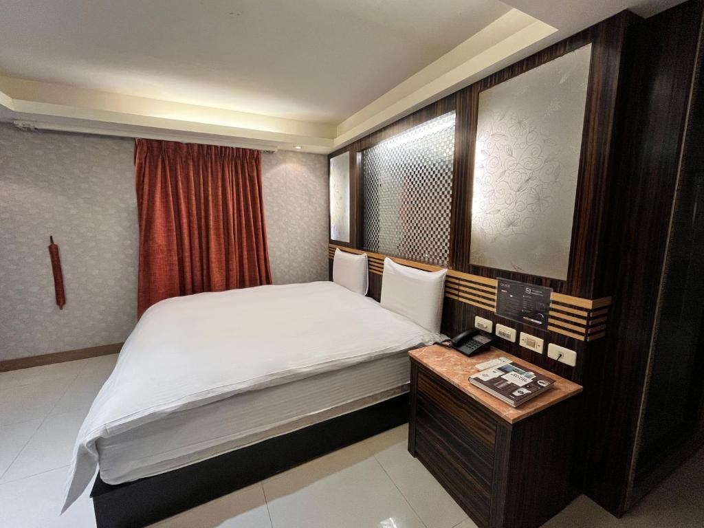 Postel nebo postele na pokoji v ubytování Guide Hotel Taipei Xinyi