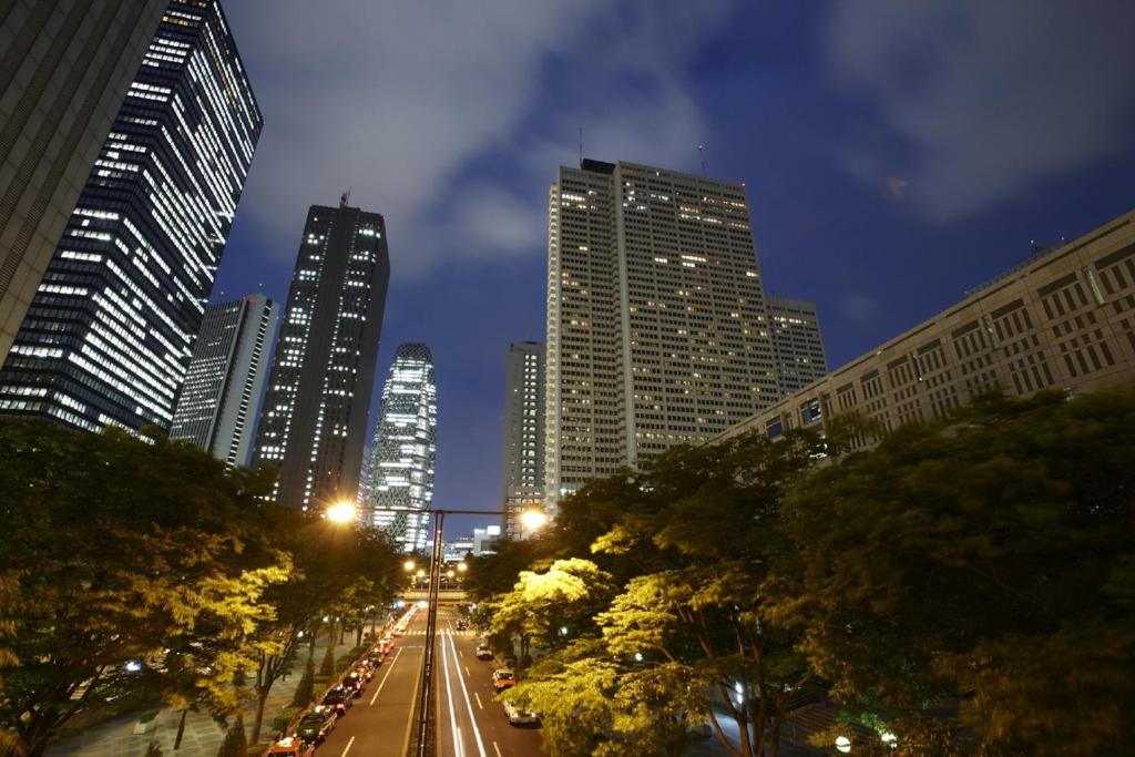 a city street at night with tall buildings at Keio Plaza Hotel Tokyo in Tokyo
