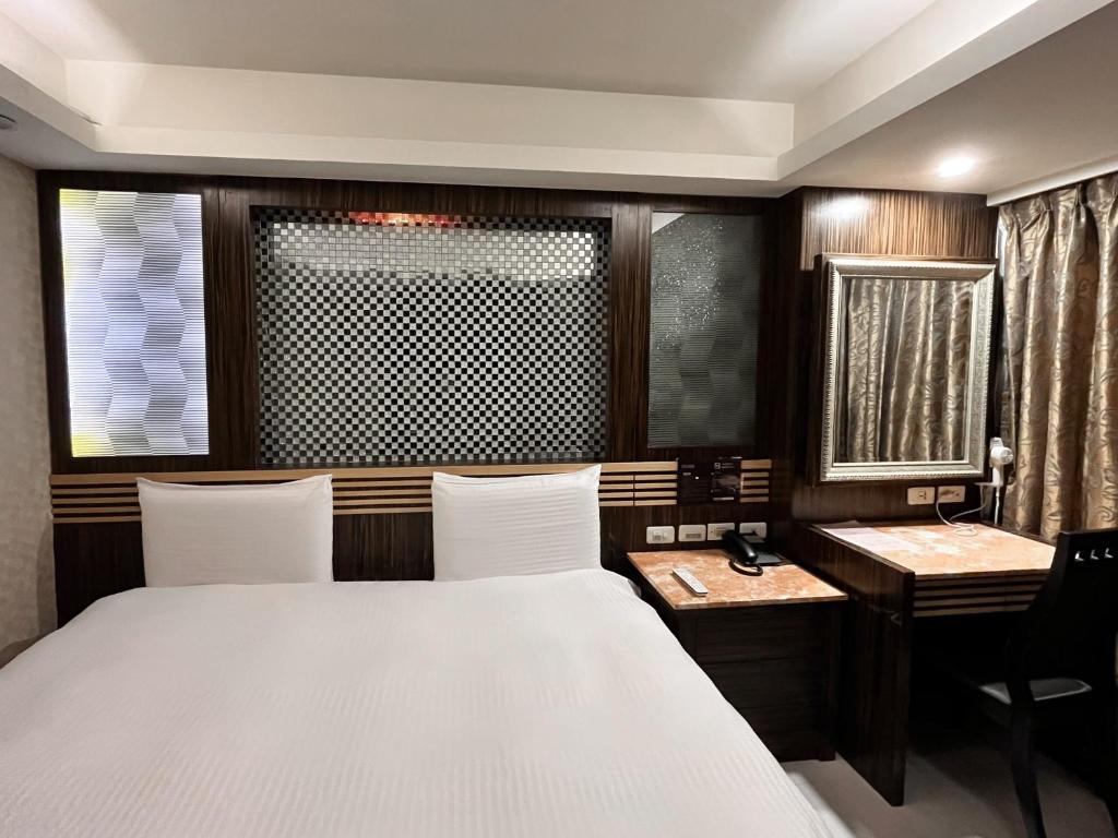 Postel nebo postele na pokoji v ubytování Guide Hotel Taipei Xinyi