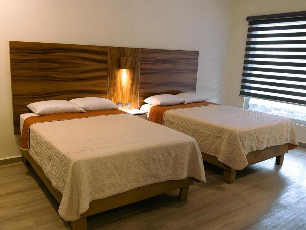a room with two beds in a room at HOTEL ISLA in Isla Aguada