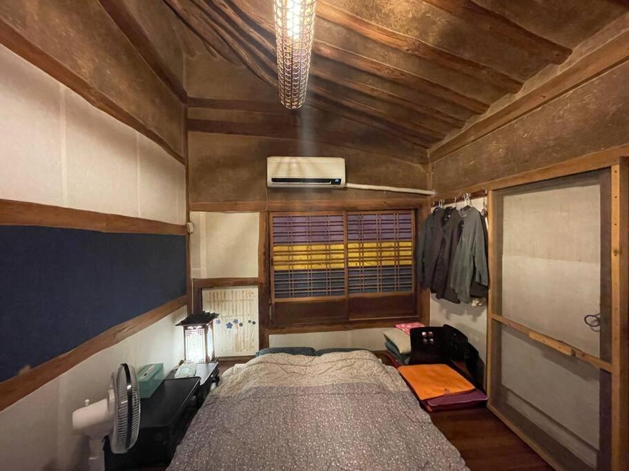 a bedroom with a large bed in a room at Mizuno Sang's Tree House 