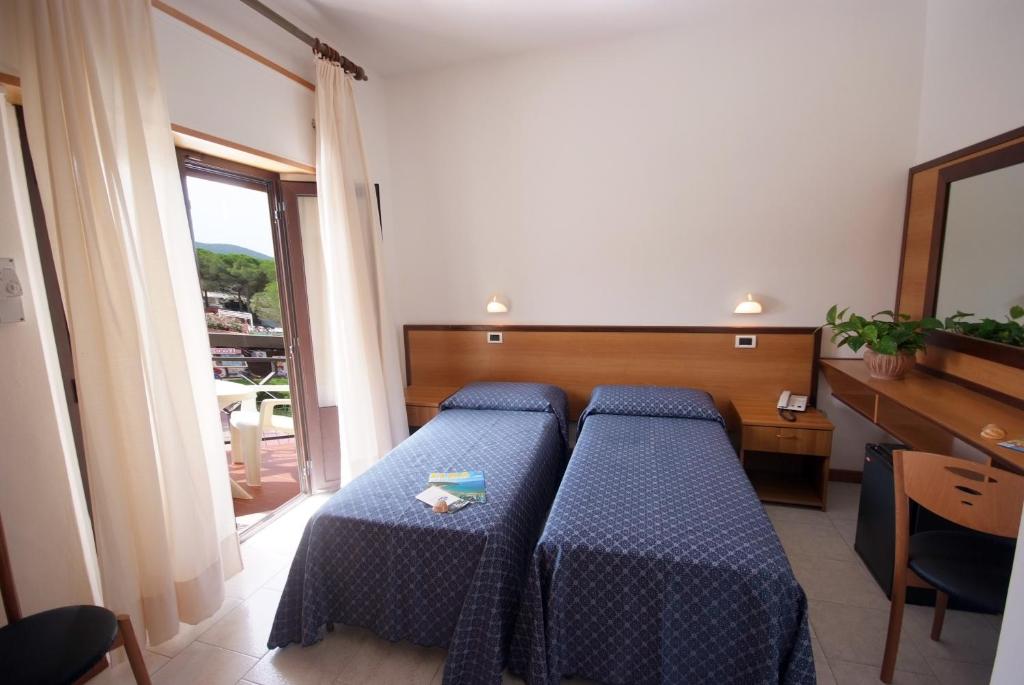 Posteľ alebo postele v izbe v ubytovaní Hotel Lilly