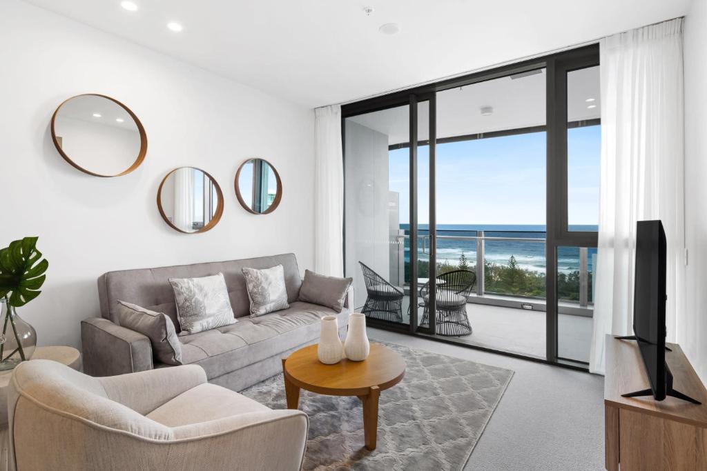 a living room with a couch and a view of the ocean at CASSA SIGNATURE - Luxury Apartments Managed by The Cassa in Gold Coast