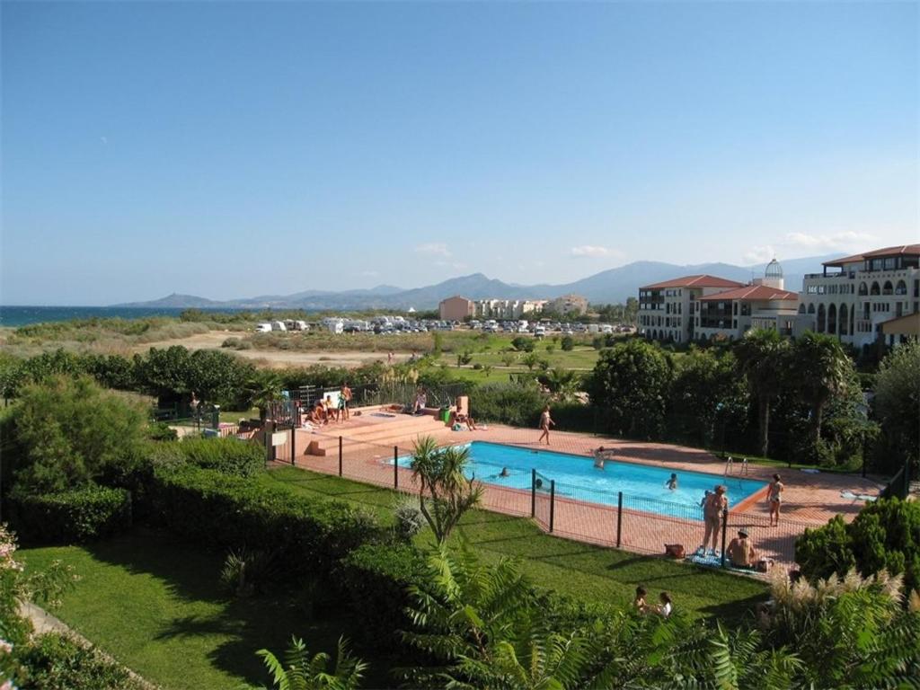 a swimming pool in a park with people around it at Appartement Saint-Cyprien, 3 pièces, 6 personnes - FR-1-106-44 in Saint-Cyprien