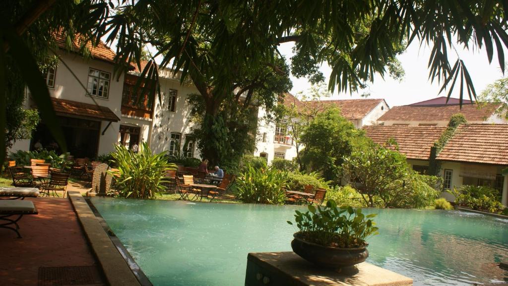 a swimming pool in the courtyard of a house at Old Harbour Hotel in Cochin