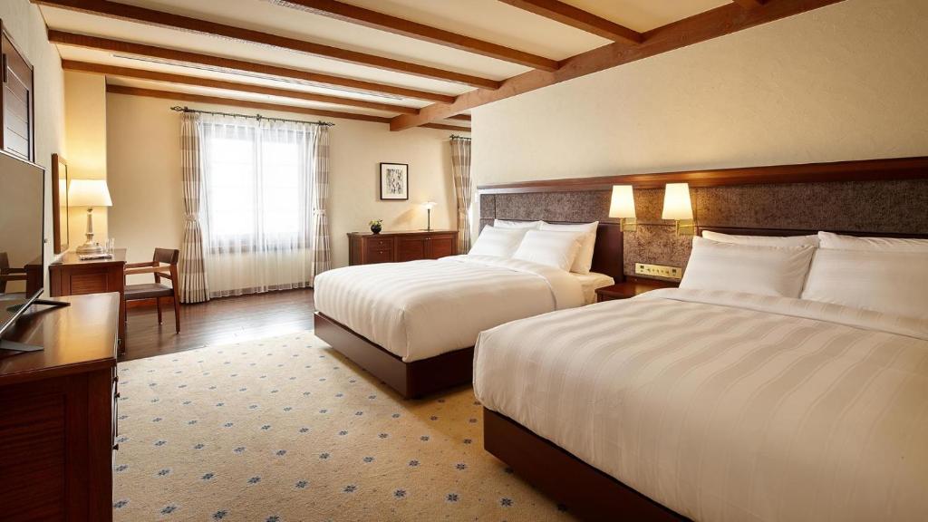 Postel nebo postele na pokoji v ubytování Lotte Arai Resort