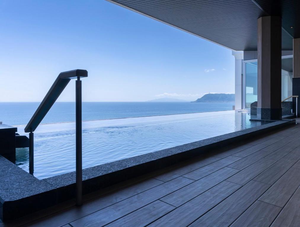 a swimming pool with a view of the ocean at Hakodate Yunokawa Onsen Umi to Akari Hewitt Resort in Hakodate