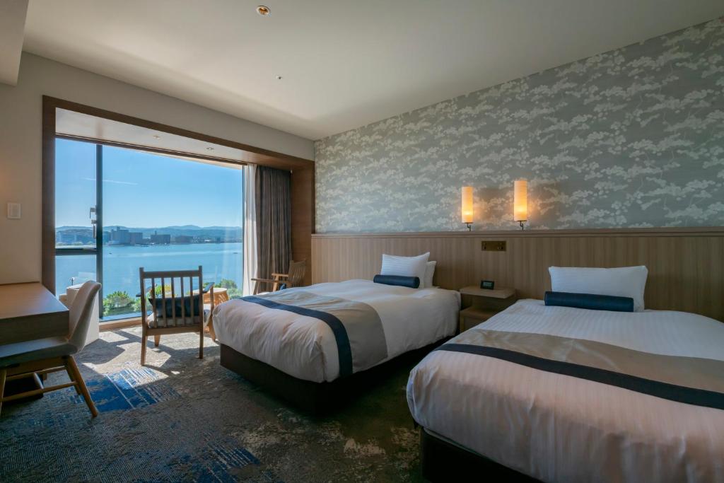 Postel nebo postele na pokoji v ubytování Hotel Ichibata