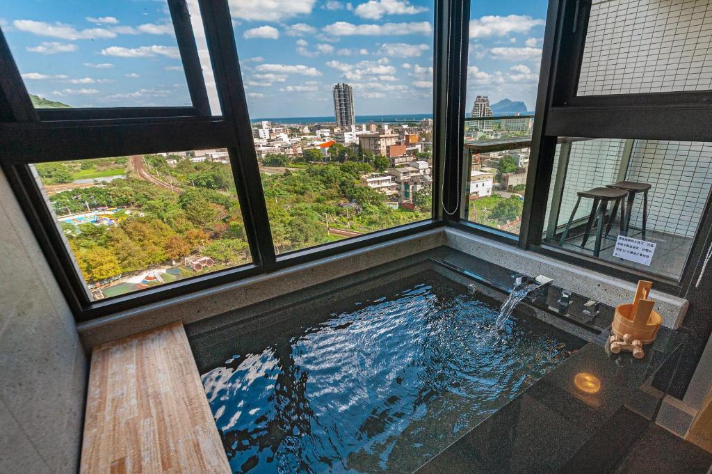 a swimming pool in a building with windows at 暮嶼 twilight island in Toucheng