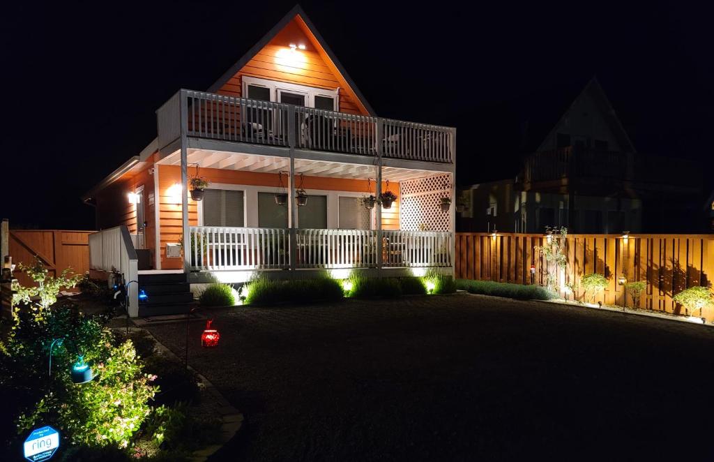 a house with lights on the front of it at night at Sunkissed, Est 2015 - 90 Sec Drive to Beach, Firepit, Privacy Fenced Yard, Gardens in Pacific Beach