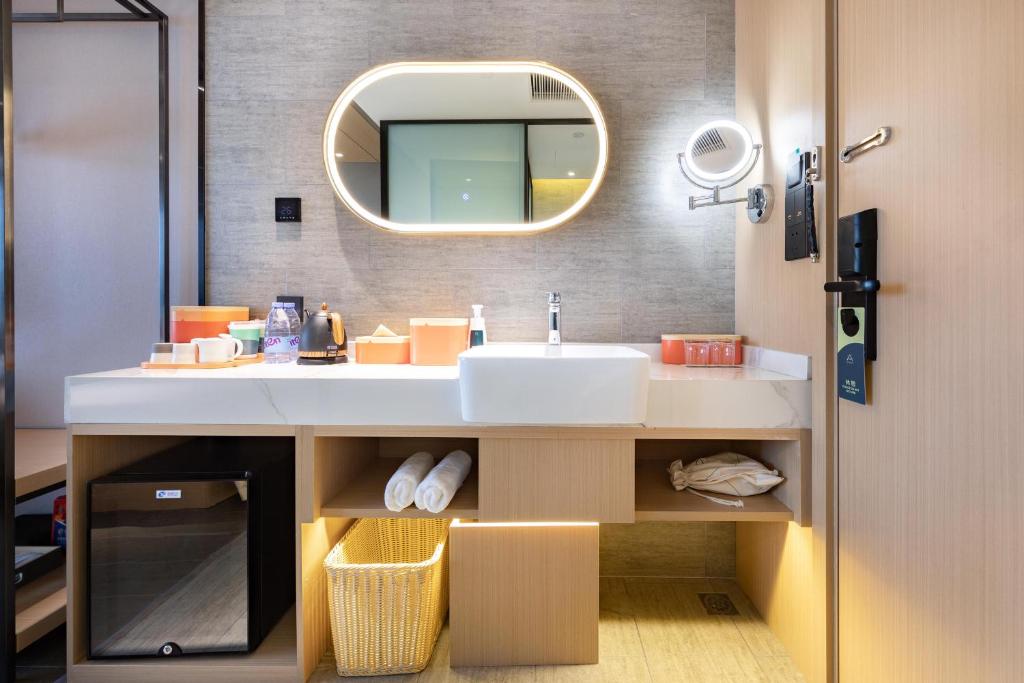 a bathroom with a sink and a mirror at Atour X Hotel Jinan Quancheng Plaza in Jinan