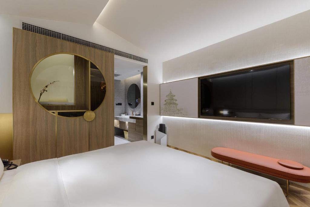 a bedroom with a large white bed and a television at Atour S Hotel Beijing Zhongguancun Beiwai in Beijing