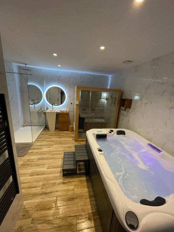 a large bathroom with a tub in the middle at Luxury spa vallon in Vallon-Pont-dʼArc