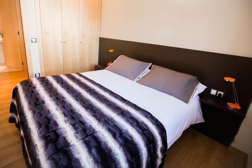 Postel nebo postele na pokoji v ubytování Apartaments Ashome