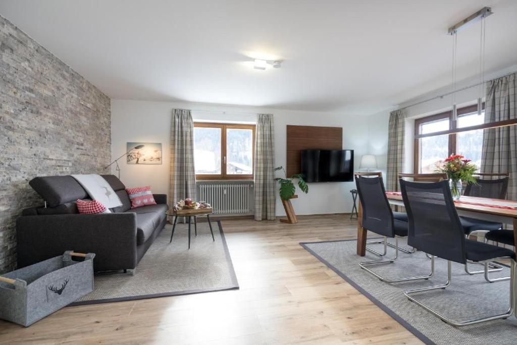 a living room with a couch and a table at Glückspilz in Obermaiselstein
