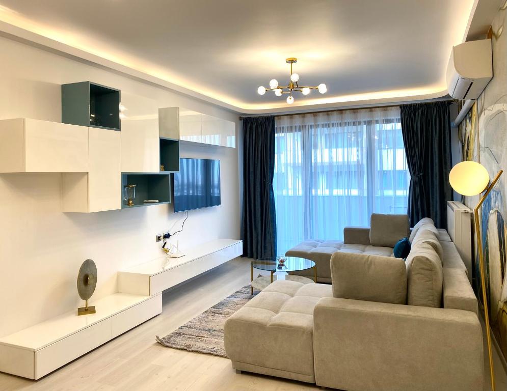- un salon avec un canapé et une table dans l'établissement Coquette Apartment, à Braşov