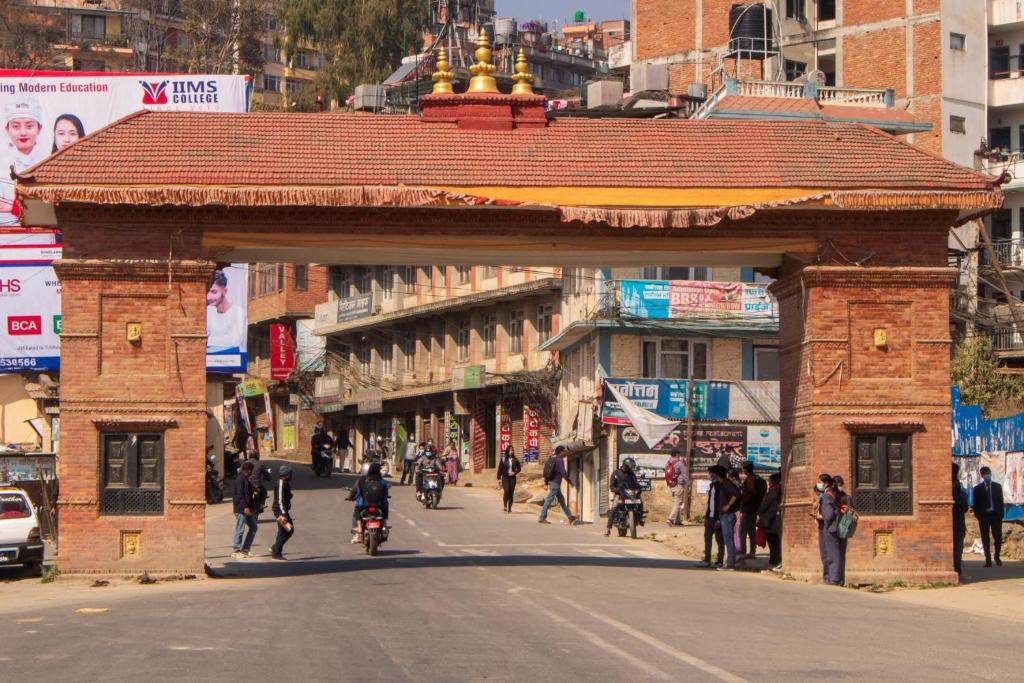 a brick archway in the middle of a street at Kirtipur Community Homestay in Kirtipur