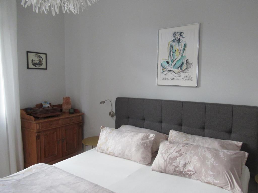 a bedroom with a bed and a picture on the wall at Ferienwohnung An der Itz in Coburg