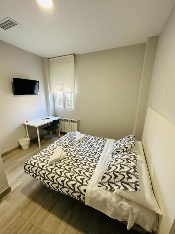 A bed or beds in a room at HOSPEDAJE CUATRO VIENTOS