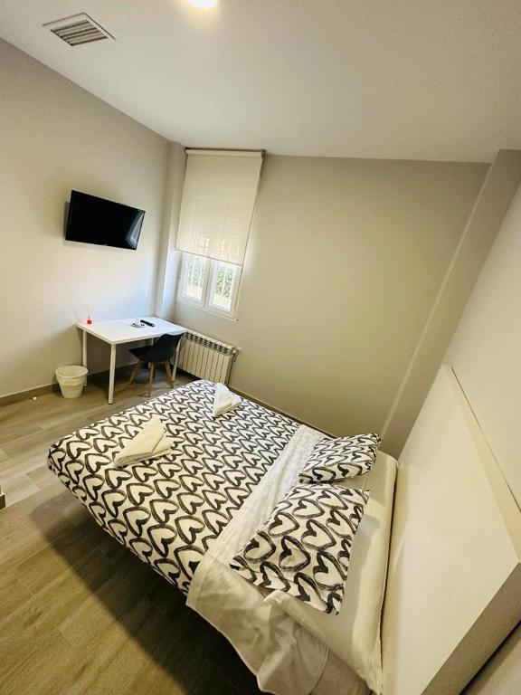 A bed or beds in a room at HOSPEDAJE CUATRO VIENTOS