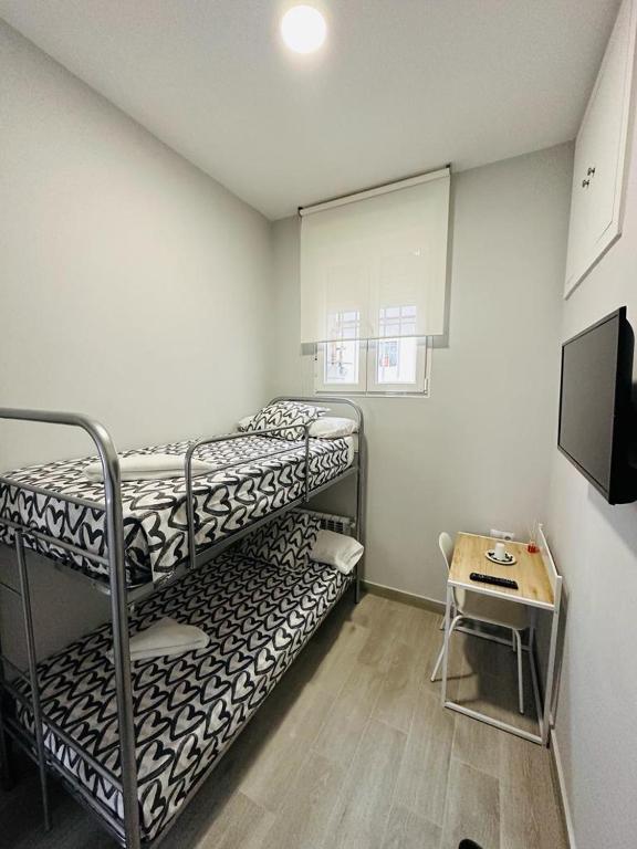 A bed or beds in a room at HOSPEDAJE CUATRO VIENTOS