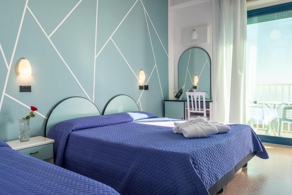 Postel nebo postele na pokoji v ubytování Hotel Royal