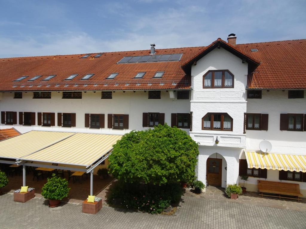 a large white building with a red roof at Gartlacher Hof in Eiselfing