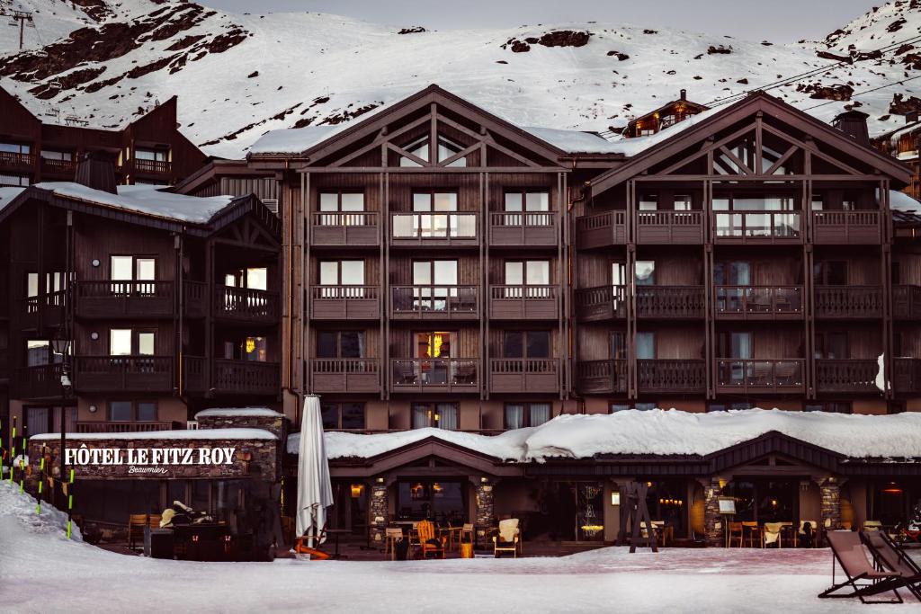 a large ski lodge with snow on the roof at Le Fitz Roy, a Beaumier hotel in Val Thorens