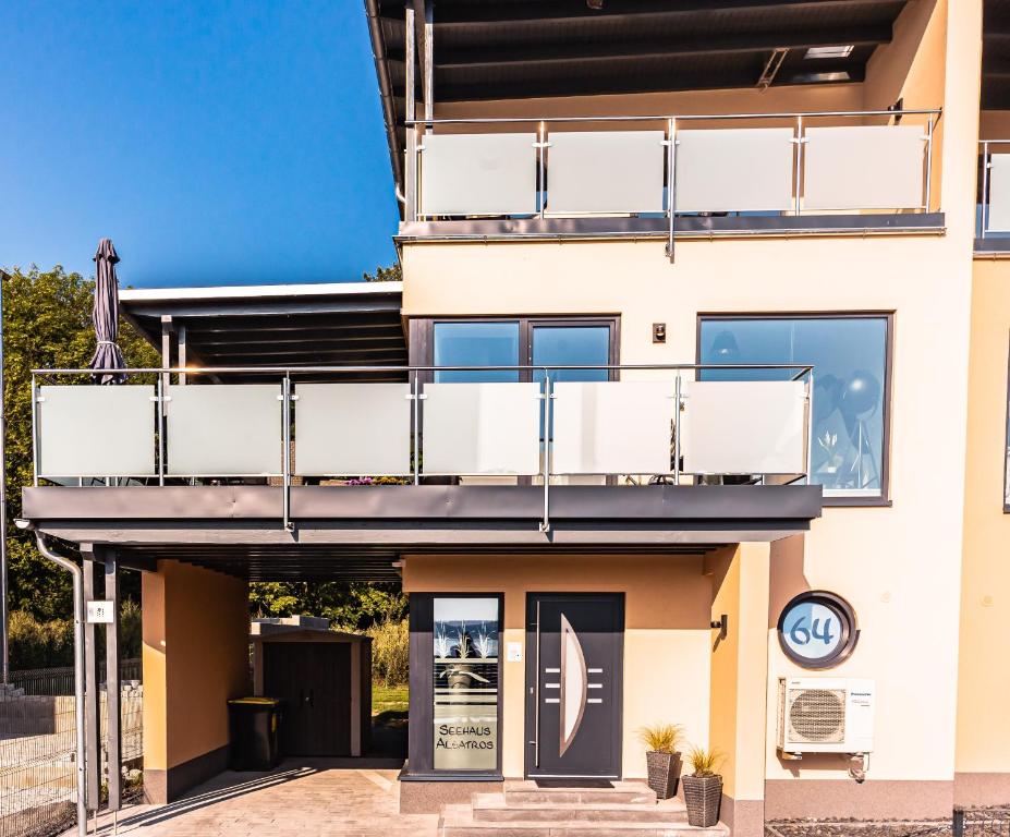 a house with a balcony on top of it at Seehaus Albatros in Kahnsdorf