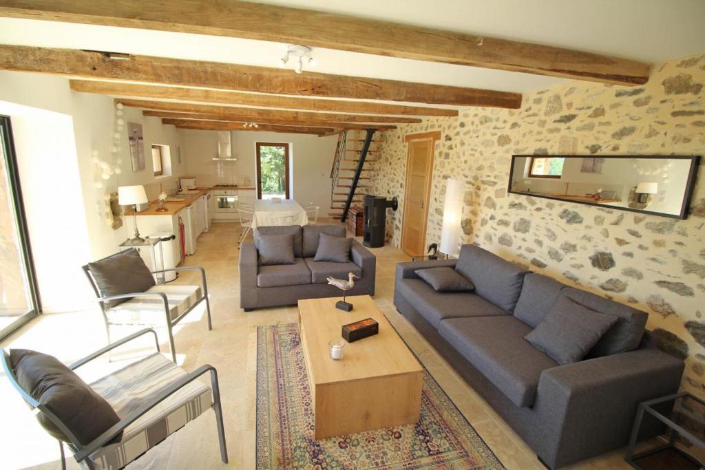 a living room with a couch and chairs and a table at Chez le bayle in Condat-sur-Vienne